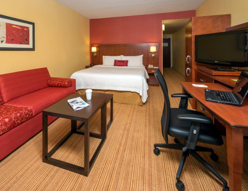 King Guestroom King bed with Sleeper Sofa. Complimentary Wifi. Two phones. Refrigerator. Work Desk. Photo 2